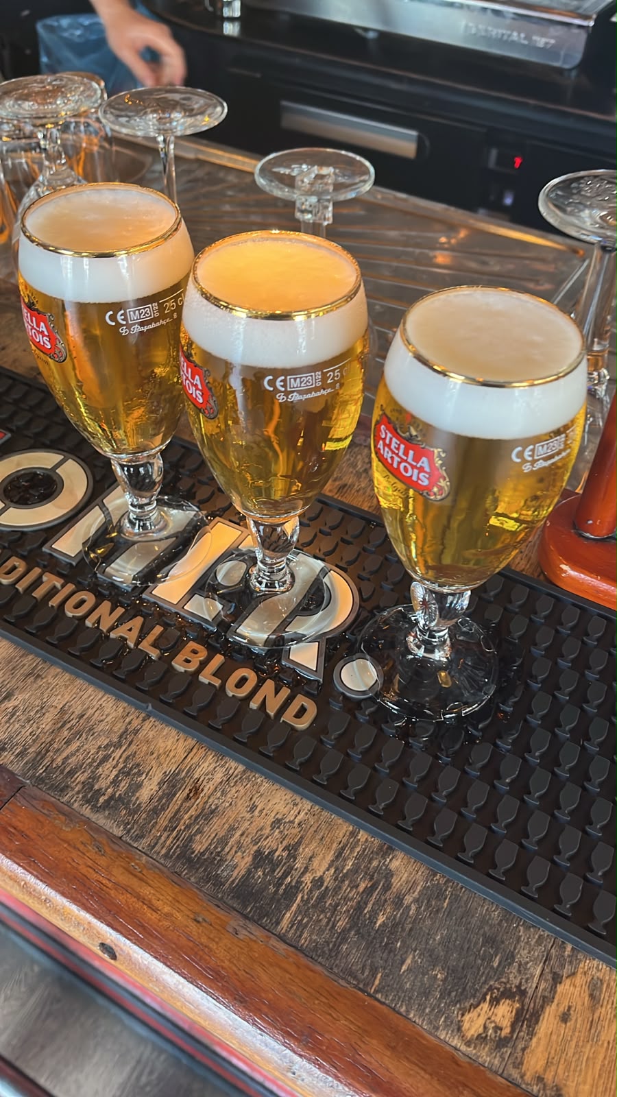 Three pints of Stella Artois on a bar